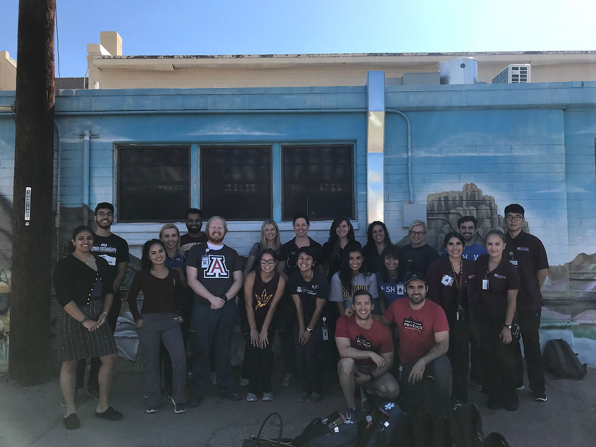 A group of street medicine volunteers posing together after outreach.